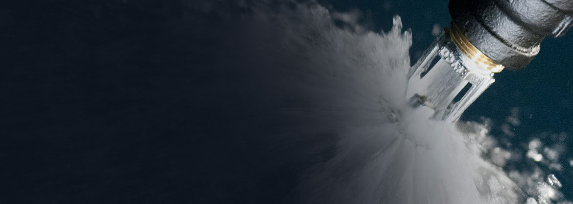 Close-up on a fire sprinkler sprinkling water